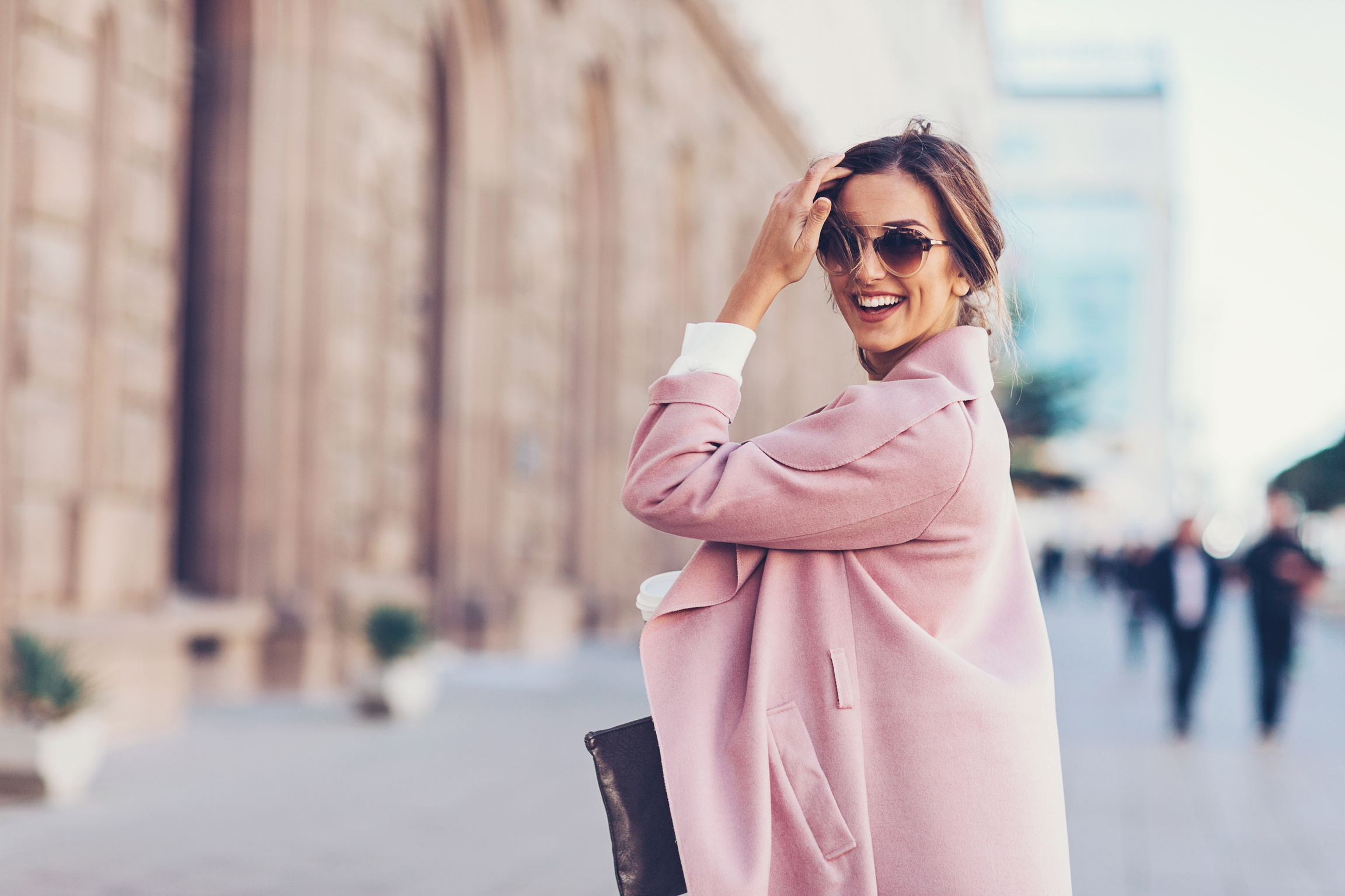 Smiling elegant woman looking back